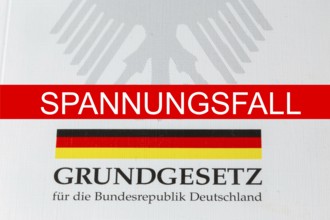 Tension case Symbolic image: SPANNUNGSFALL lettering, with the German Basic Law behind it