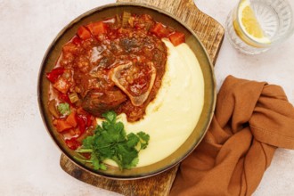 Ossobuco, stewed meat knuckle on the bone, with mashed potatoes, and oats and spices, homemade, no