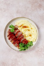 Roast duck breast, sliced with mashed potatoes, on a white plate, close-up, no people