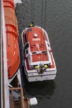 Lifeboat, cruise ship being lifted onto a cruise ship, Juneau, Alaska, USA