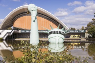 Symbolisation of a Statue of Liberty submerged in water in front of the Haus der Kulturen der Welt