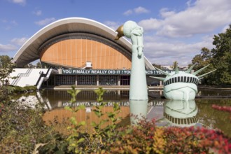 Symbolisation of a Statue of Liberty submerged in water in front of the Haus der Kulturen der Welt