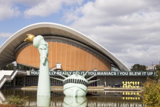 Symbolisation of a Statue of Liberty submerged in water in front of the Haus der Kulturen der Welt