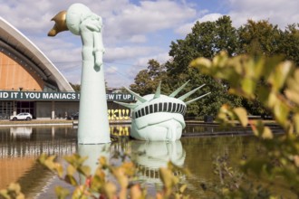 Symbolisation of a Statue of Liberty submerged in water in front of the Haus der Kulturen der Welt