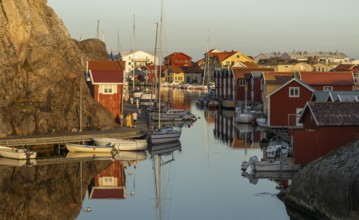 Colourful boathouses and boats in the harbour of Smögen, evening mood, Smögenbryggan, Västra