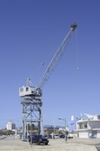 Old harbour crane with a white stork nest, Portimao, Algarve, Portugal