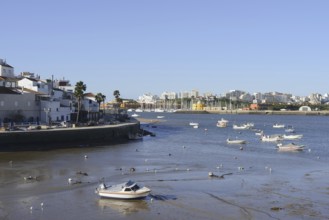 View over the mouth of the river Arade with fishing boats to Portimao, Ferragudo, Algarve, Portugal