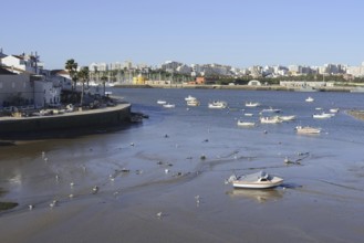 View over the mouth of the river Arade with fishing boats to Portimao, Ferragudo, Algarve, Portugal