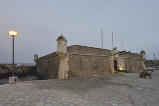 Forte da Ponta da Bandeira fortress at dusk, Lagos, Algarve, Portugal