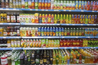 A shelf full of bottles of juices and other drinks in various flavours, Gntunik supermarket,