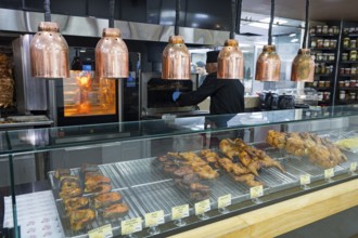 Various meats are prepared on the grill under copper lamps, Gntunik supermarket, Aragazotn