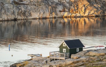 Small green boathouse, evening mood at sunset, Smögen, Smögenbryggan, Västra Götalands Län,