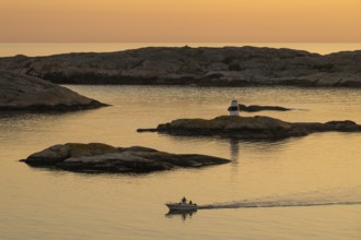 Motorboat in archipelago at sunset, Smögen, Smögenbryggan, Västra Götalands Län, Bohuslän, Sweden