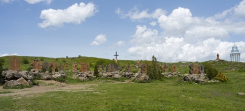 Panoramic view of a landscape with stone pillars and peaceful surroundings under a blue sky,