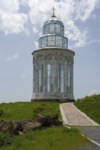 Glass church with decorative cross in a meadow under a blue sky, Garden of Eternity, Aparan,