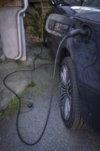 An electric car being charged, private house, Fjällbacka, Bohuslän, West Sweden, Sweden