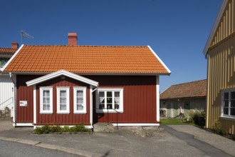 Red wooden house under a bright blue sky, typical Swedish style, Fjällbacka, Bohuslän, West Sweden,
