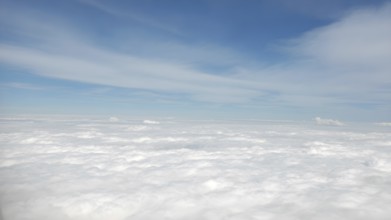 Aerial view on white fluffy clouds. View of the clouds from above, AI generated