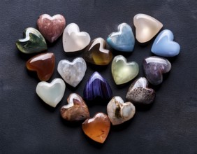 An artistic arrangement showcasing a variety of heart-shaped gemstones with vivid colors placed on