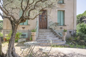 Typical Midi architecture in the south of France: a rustic stone staircase with ornate banisters
