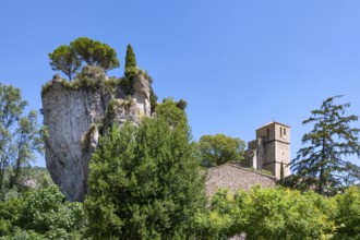 The Romanesque church of Sainte-Marie with its massive bell tower stands embedded in the green of