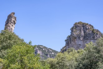 Two prominent dolomite cliffs formed by erosion - a towering peak on the left and a massive rock