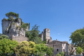 The Romanesque church of Sainte-Marie with its massive bell tower stands embedded in the green of
