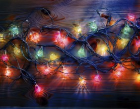 Vivid string lights in captivating colors arranged on a wooden surface, perfect for evoking a