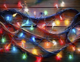 Vivid string lights in captivating colors arranged on a wooden surface, perfect for evoking a
