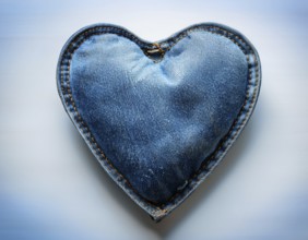 A beautiful heart-shaped denim pillow, symbolizing love and creativity, designed from repurposed