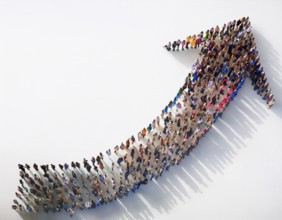 A diverse crowd of people gathered to form an upward-pointing arrow symbol, representing growth,