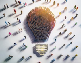 Large group of individuals assembled to form the shape of a lightbulb, symbolizing ideas,