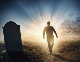 A silhouette of a lone figure walking off a gravestone, The scene evokes Resurrection thoughts