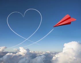 A red paper airplane depicted in flight with an artistic heart-shaped trail. The blue sky