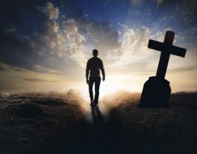 A silhouette of a lone figure walking off a gravestone, The scene evokes Resurrection thoughts
