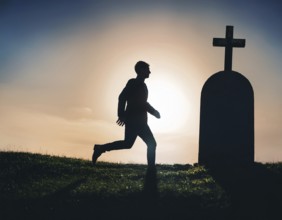 A silhouette of a lone figure walking off a gravestone, The scene evokes Resurrection thoughts