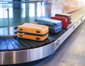 Baggage on a conveyor belt at an airport providing a travel and departure theme, AI generated