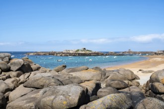 The wide bay of Tregastel on the Cote de Granit Rose shows the turquoise blue sea with white