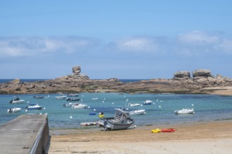 On the harbour beach of Tregastel on the Cote de Granit Rose, small sailing boats are moored next