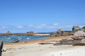 On the harbour beach of Tregastel on the Cote de Granit Rose, small sailing boats lie on the light