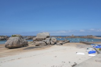 On the harbour beach of Trégastel on the Côte de Granit Rose, small boats lie on the light sand at
