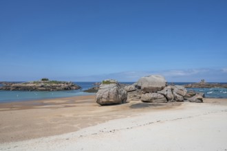 Spectacular pink granite rocks, sculpted by wind and sea, pile up on the beach of the Cote de