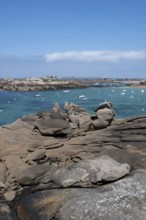 A picturesque coastal view of the pink granite coast near Tregastel shows the bay with the