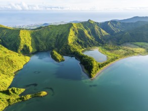Lagoa do Fogo Lake on Sunny Morning. Green Lush Hills, Mountains and Atlantic Ocean. Azores, Sao
