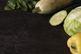 Green vegetables lie on a brown stone
