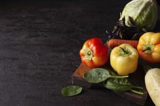 Zucchini cabbage spinach pepper tomatoes lie on a brown background space for text
