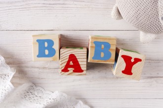 Cubes with letters Baby on a rustic background