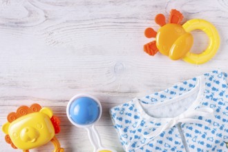 Things for a newborn on a white wooden background