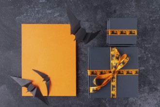 Gifts for the celebration of Halloween, orange place for text, on a black background