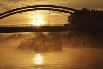 Ship on the Datteln-Hamm Canal in the morning fog at sunrise, Bergkamen, North Rhine-Westphalia,